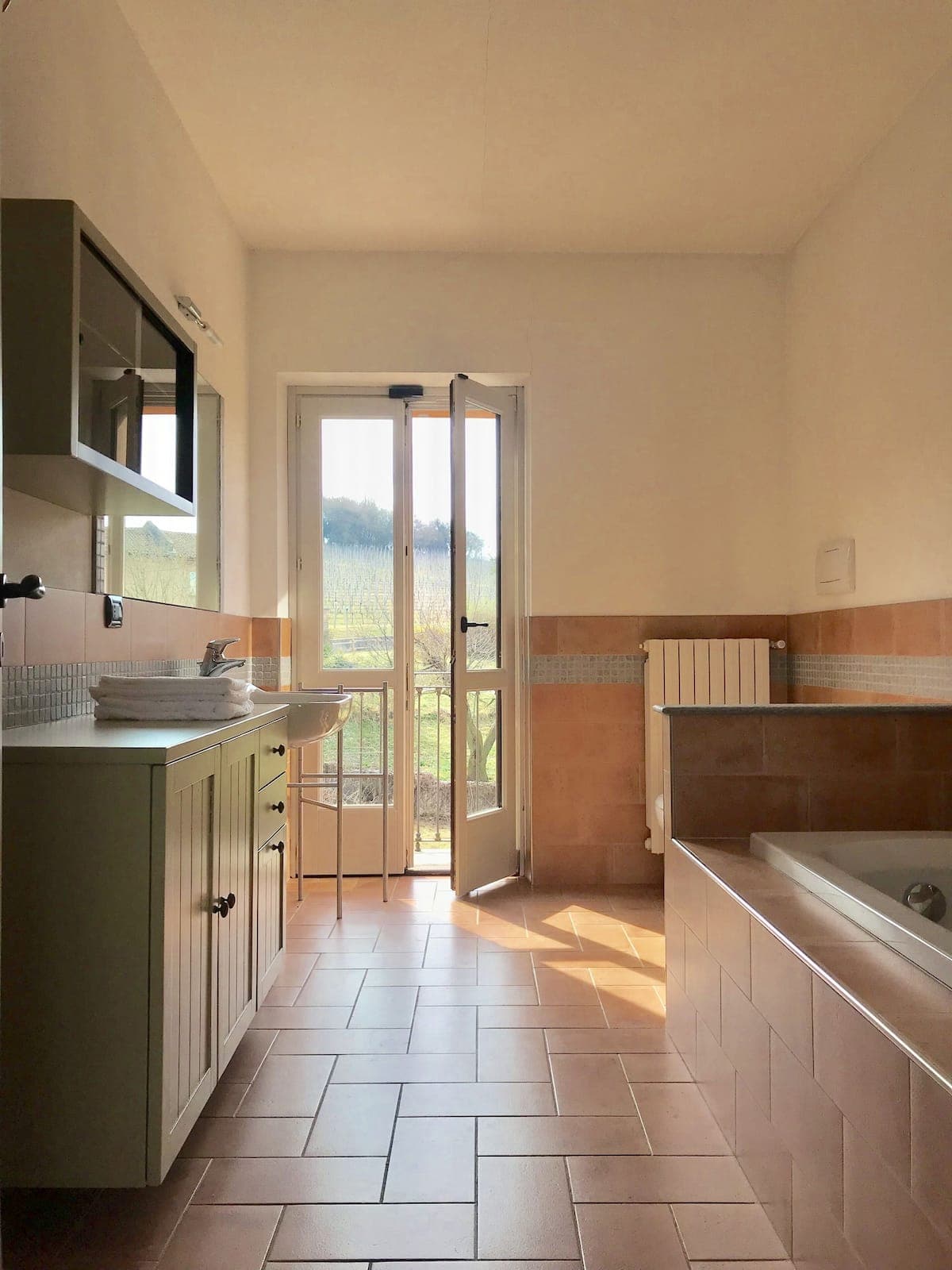 Bathroom with soaking tub and balcony